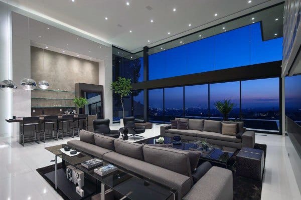 Modern, luxurious living room with bar and floor-to-ceiling windows