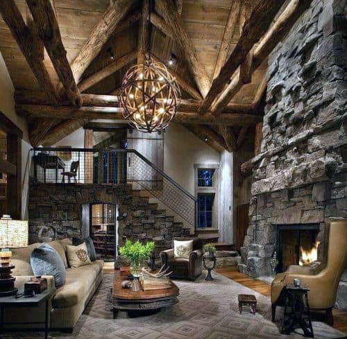 Rustic cabin-style living room with stone walls and fireplace 