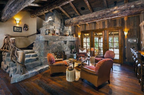 Wooden cabin living room with stone fireplace and steps 