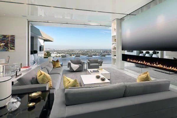 Long, luxurious living room with huge TV and city views
