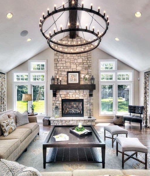 Country-style living room with stone fireplace and chandelier