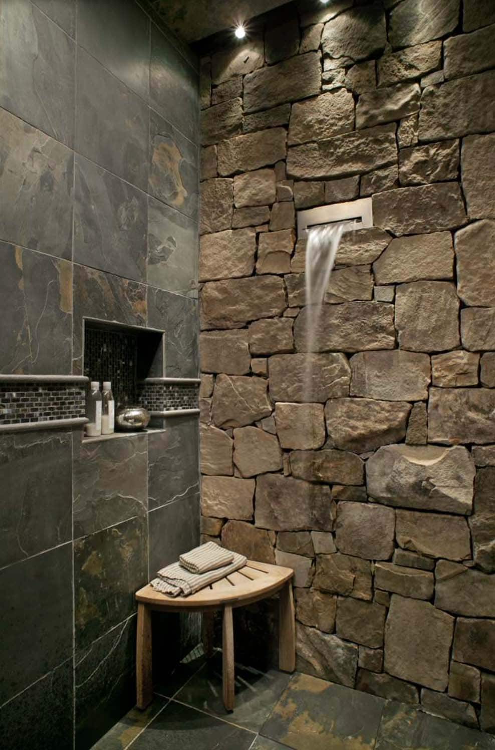 Rustic stone shower with waterfall shower head