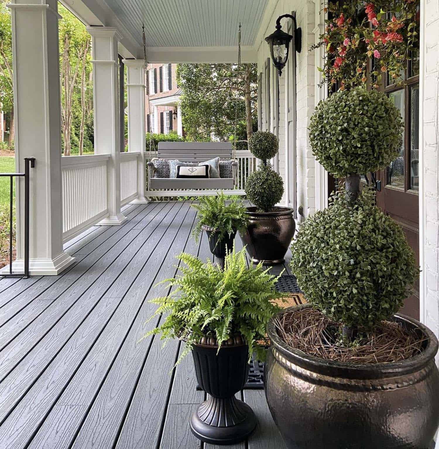 Spring Porch with Boxwood Topiaries and Porch Swing