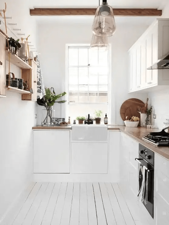 a cool L-shaped Scandinavian kitchen with butcher block countertops, open shelving and wooden beams
