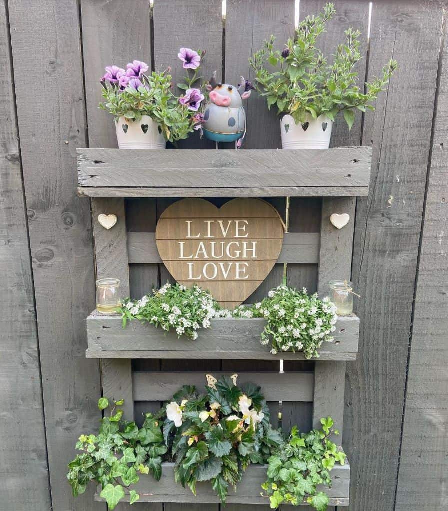Creative pallet garden design with potted plants