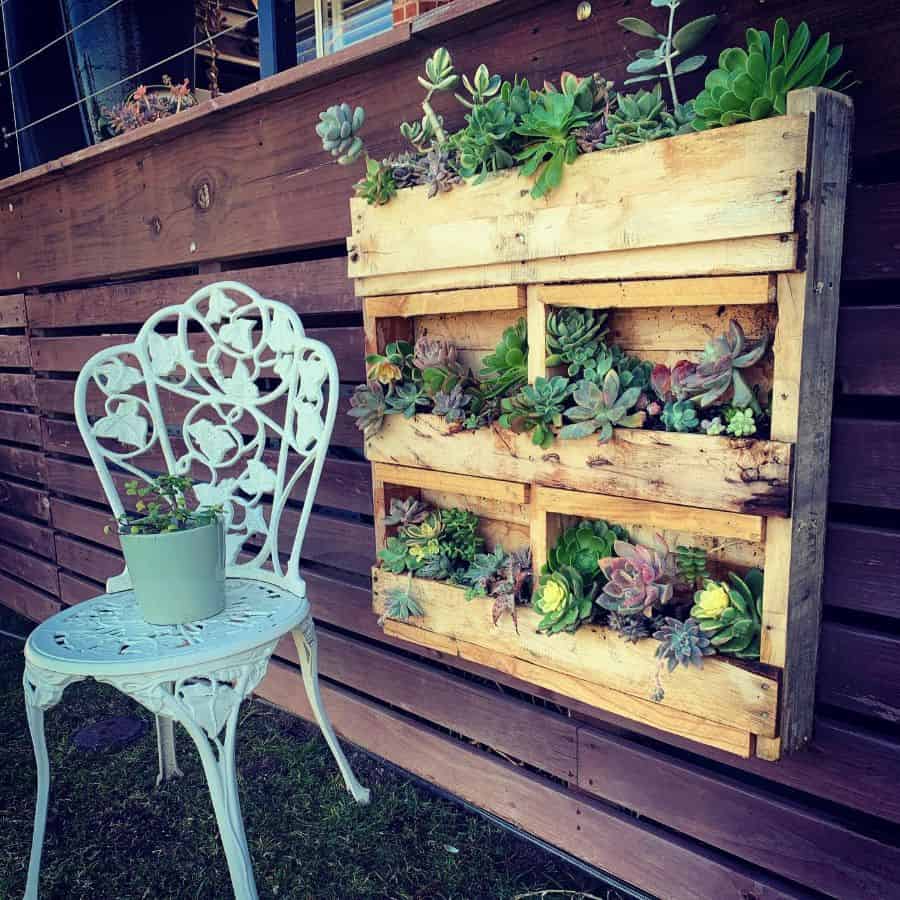 Wooden wall pallet gardens with accent chair 
