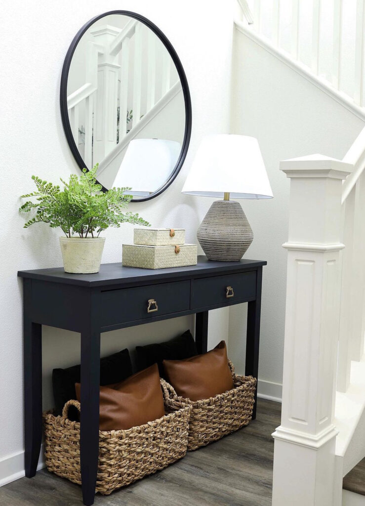 Simple black entryway table with pillow basket storage