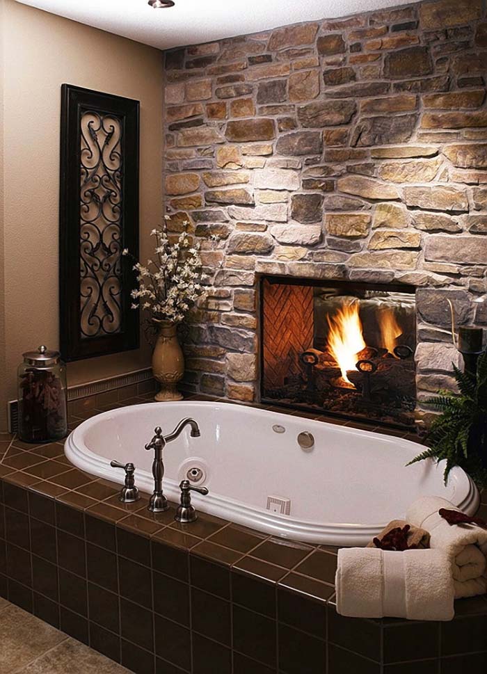 Built-in fireplace in the stone bathroom wall