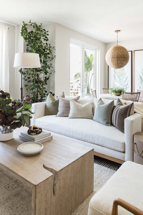 A neutral and chic living and dining area with great flower pots and trees is a very fresh idea
