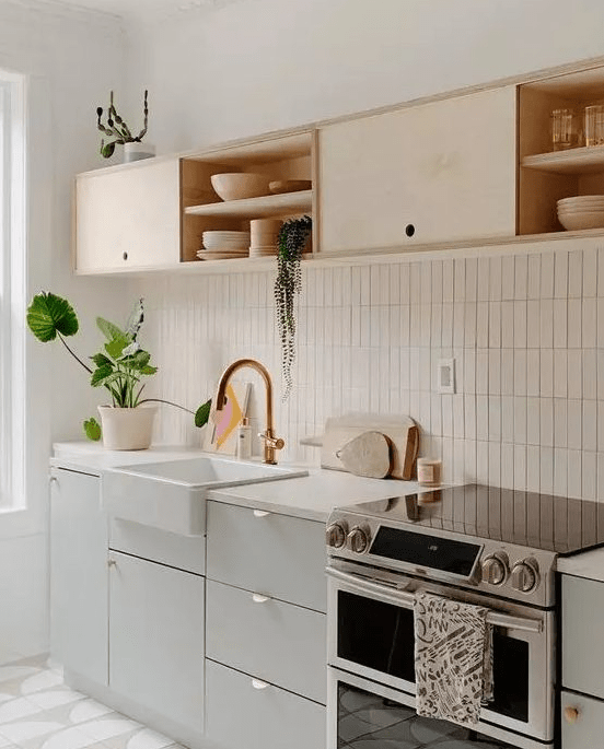 A chic dove gray and light plywood kitchen with white countertops and a white stacked tile backsplash