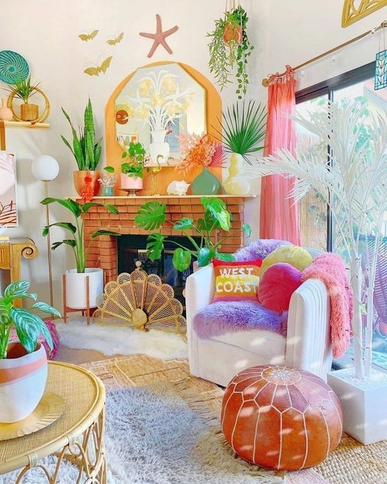 A living room in dopamine decor with a brick fireplace, a chair with statement pillows, potted plants and some lamps