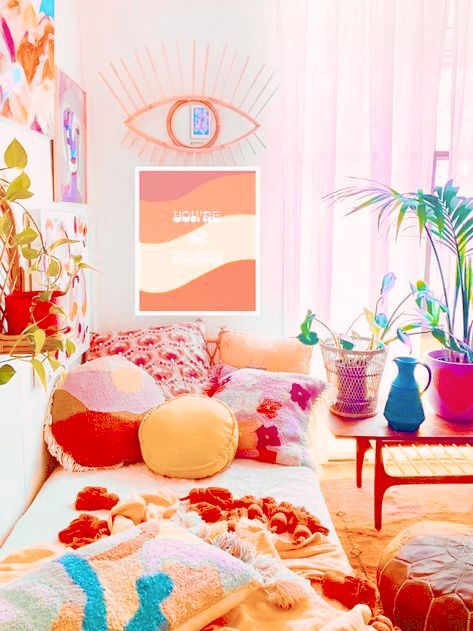 a dopamine decor area with a colorful gallery wall, a daybed with bright pillows, and a coffee table with colorful planters