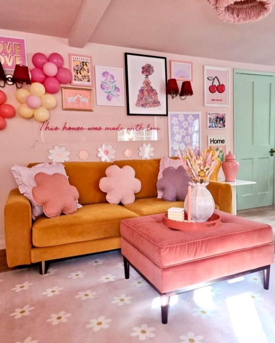 A fantastic living room with dopamine decor, blush walls and ceiling, a mustard sofa, a pink ottoman and a crazy gallery wall