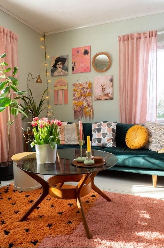 a pretty, dopamine-infused living room with bright green walls, a dark green sofa, printed pillows, a statement gallery wall, and a pink and orange rug