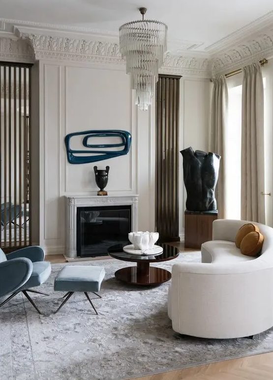 an elegant living room with a curved white sofa and memorable decor and artwork that continues the room's unique style