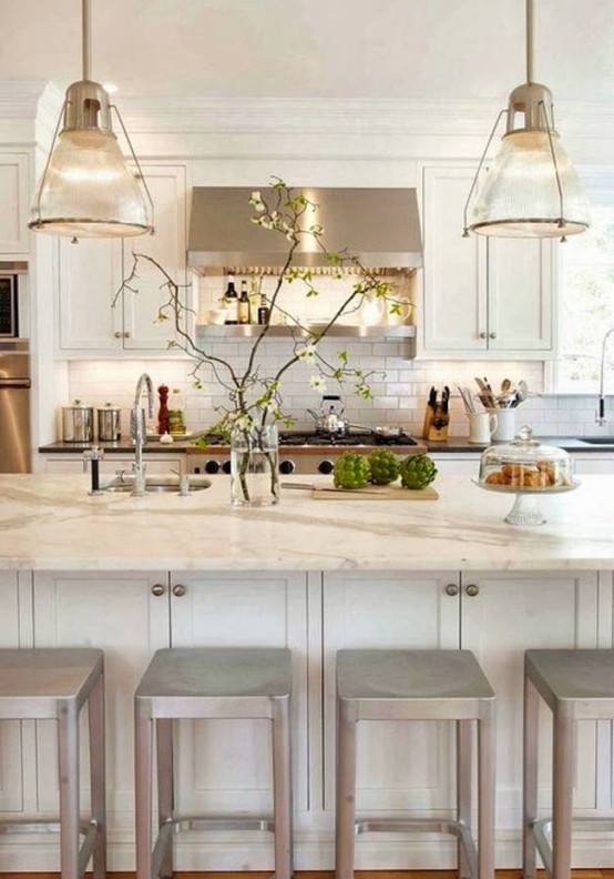 A sleek, neutral kitchen with shaker cabinets, a large island, stainless steel appliances, and pendant lights is amazing