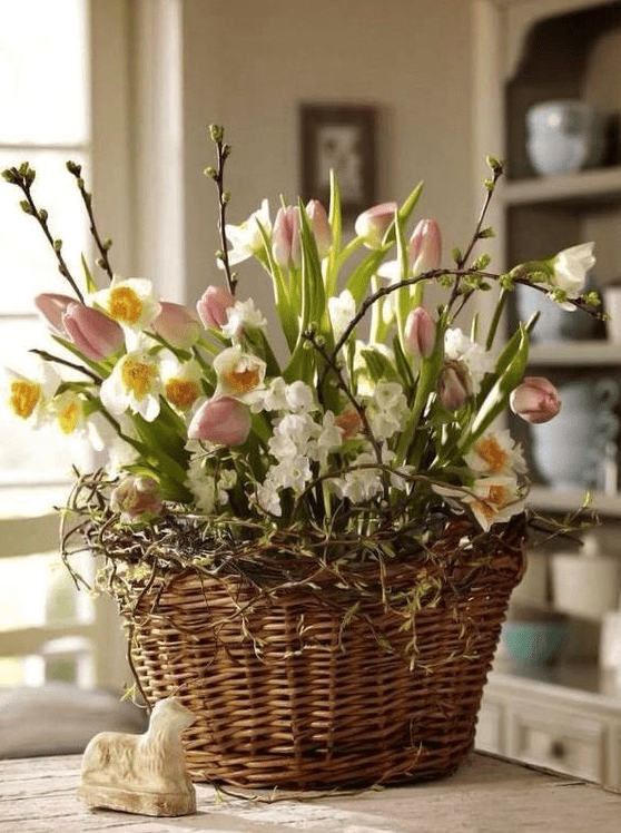 A basket of vines, pink tulips and daffodils, pussy willows is a cool Easter-inspired arrangement