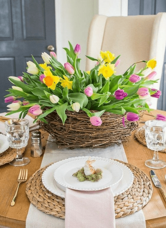 A bright centerpiece made from a nest of purple and white tulips and daffodils is a cool idea for spring and Easter