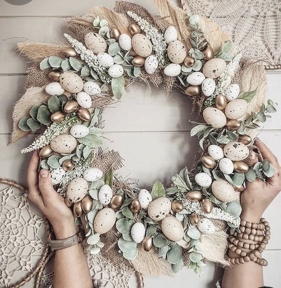 A sweet, rustic Easter wreath made from burlap, leaves, astilbe, faux speckled and gilded eggs makes a beautiful decoration
