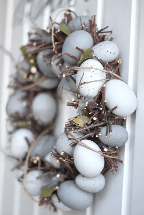 A unique rustic Easter wreath made with twigs, speckled eggs, and leaves is a cool idea for a rustic or organic outdoor space