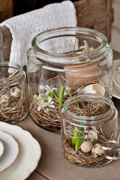 Rustic Easter decorations with jars filled with vines, greenery, flowers and speckled eggs are a cool idea for spring
